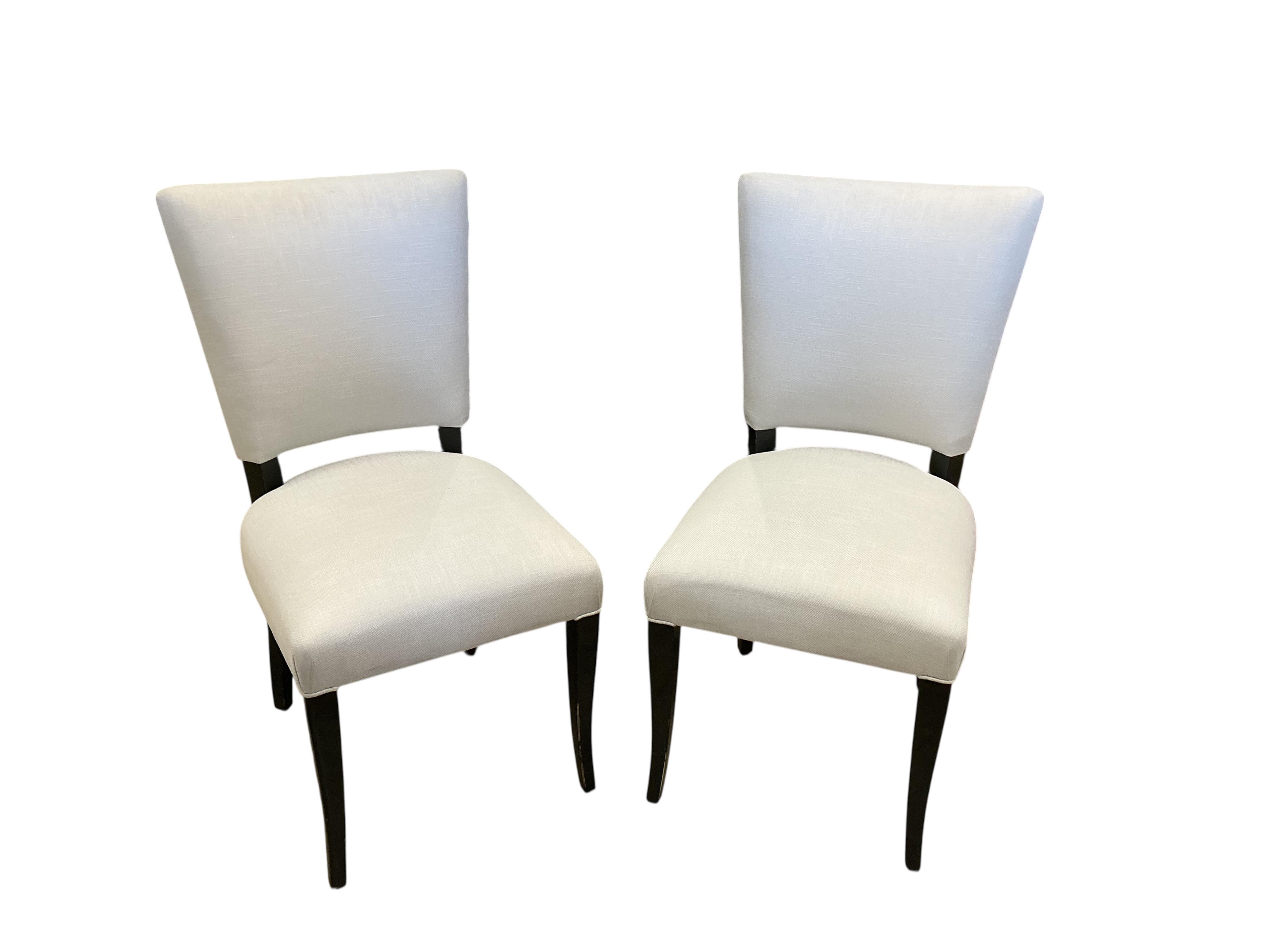 Seven contemporary ebonised and grey fabric elbow chairs, five with arms